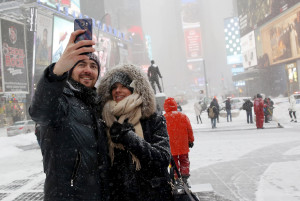 A couple takes a selfie during a snowstorm at Times Square in the Manhattan borough of New York