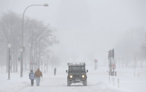 People walk during a winter storm on Pennsylvania Avenue in Washington